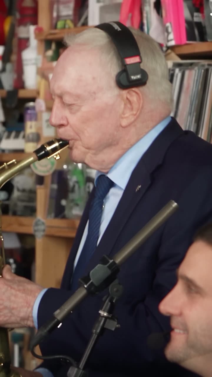 The sax steps forward for a solo while the band holds the groove, taking the performance to its final beat.